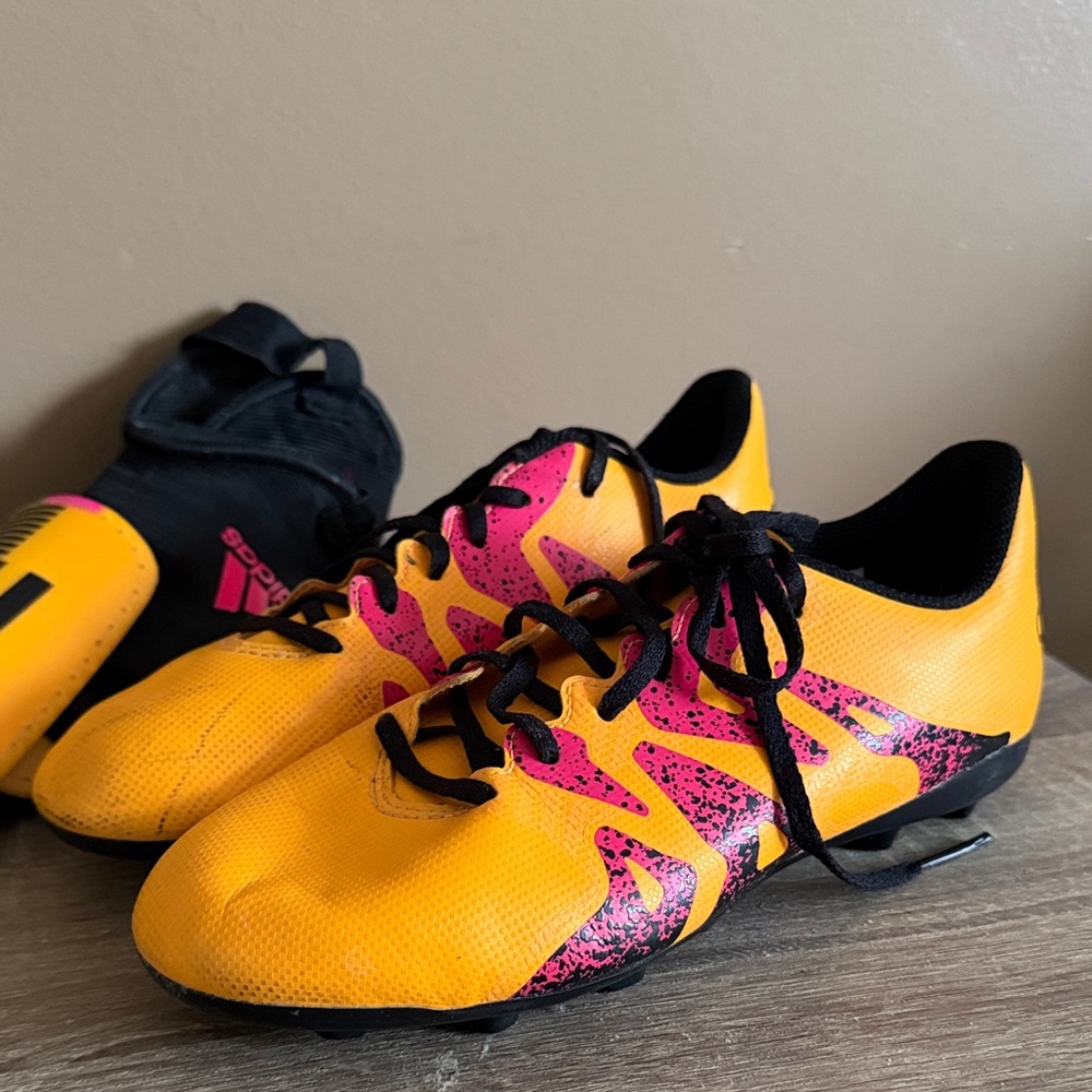 Adidas Yellow and Pink Soccer Cleats and shin guards